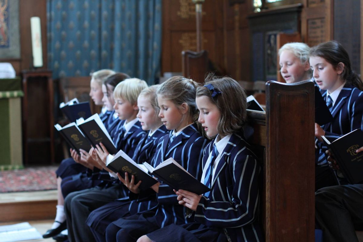 School children with hymn books and music