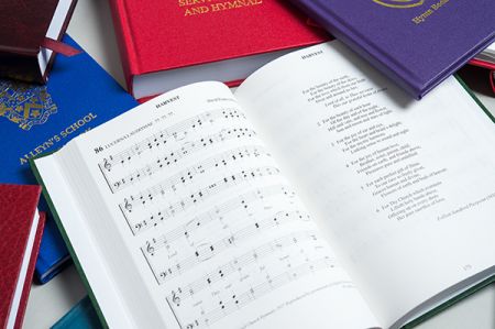 Bespoke hymn books with one book open at Harvest page
