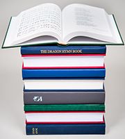 Stack of bespoke hymn books showing top book open